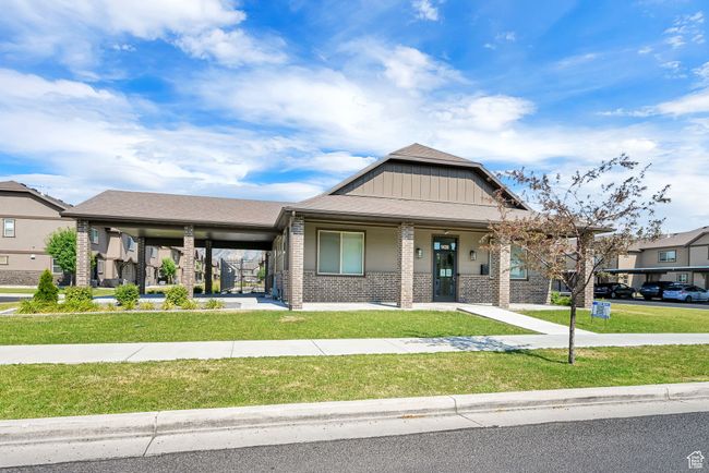 View of front of house featuring brick siding, a front yard, and covered porch | Image 31