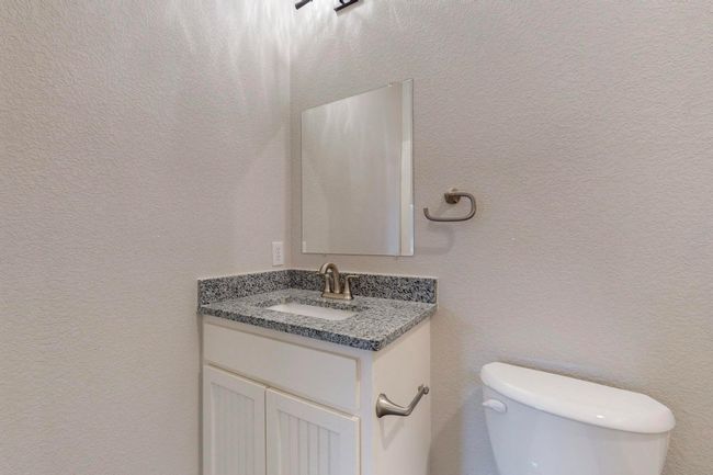 Bathroom featuring toilet and vanity | Image 25