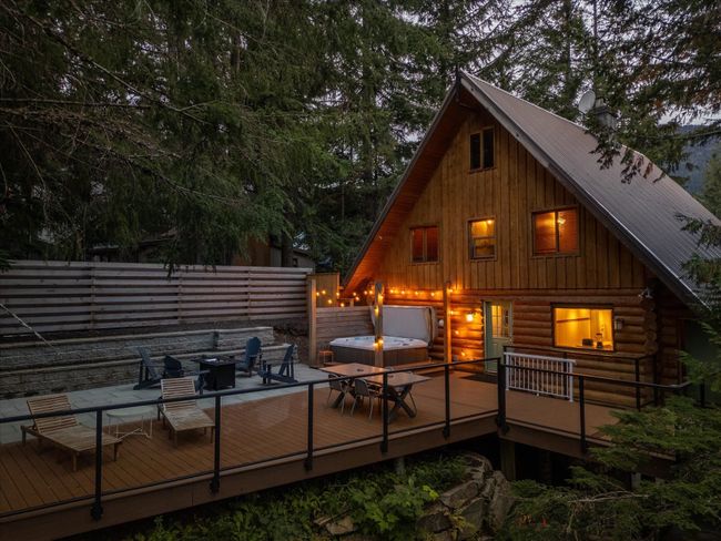 Back of house featuring metal roof, fence, log exterior, and a wooden deck | Image 30