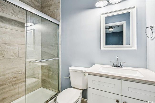 Bathroom with a shower stall and vanity | Image 15