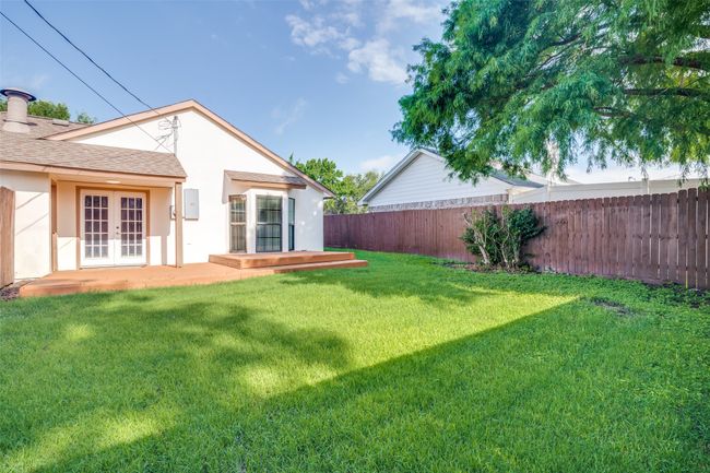 Fenced backyard featuring french doors | Image 26