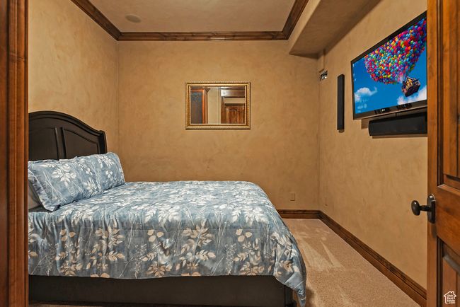 Bedroom featuring baseboards, ornamental molding, and carpet | Image 44