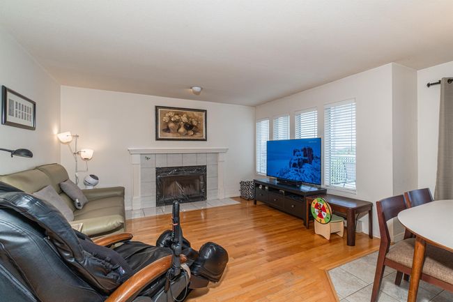 Living area featuring a fireplace and light wood-style flooring | Image 12