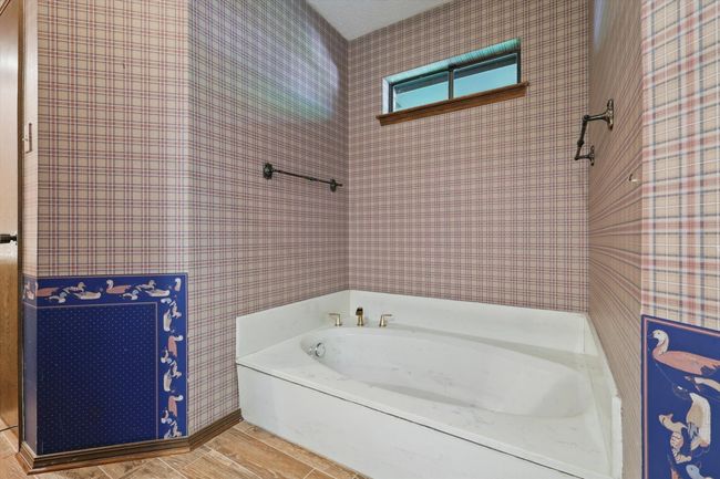 Bathroom featuring a garden tub and wood finished floors | Image 27