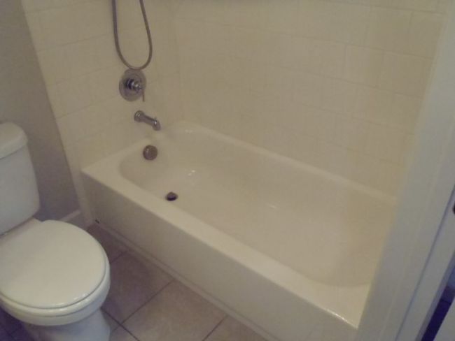 Full bath featuring washtub / shower combination and tile patterned floors | Image 36