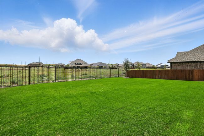 Fenced backyard with a residential view | Image 30