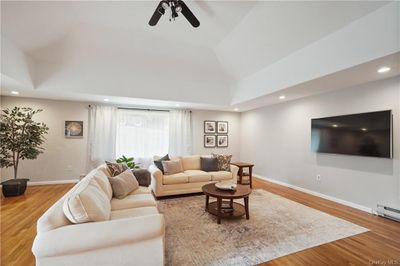 Living room with ceiling fan, hardwood / wood-style floors, and high vaulted ceiling | Image 1