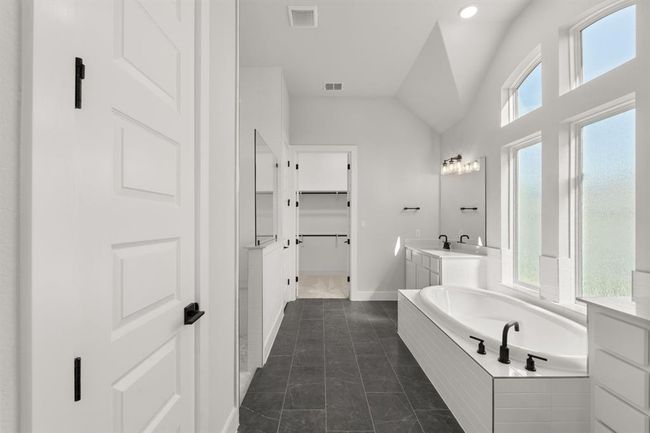 Bathroom featuring vanity, a garden tub and a walk in closet | Image 21