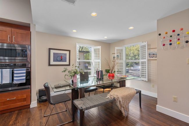Dining space with dark wood-type flooring, visible vents, baseboards, and recessed lighting | Image 5