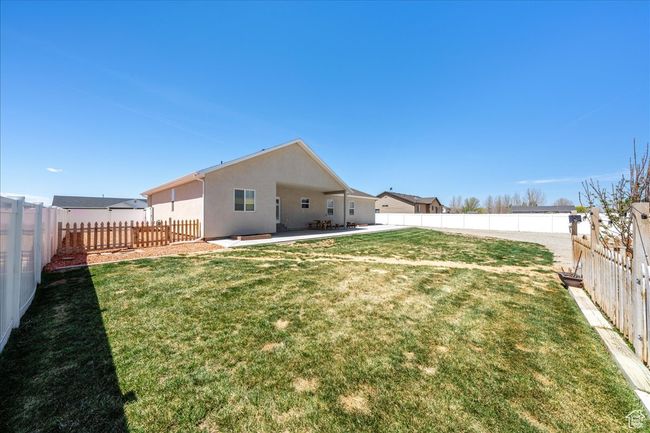 View of yard with a patio area and a fenced backyard | Image 59