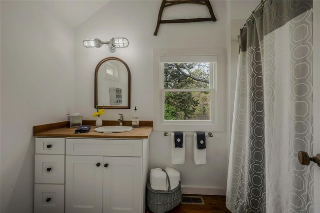Full bath with vanity, vaulted ceiling, and wood finished floors | Image 10