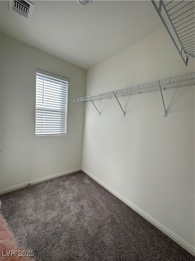 Spacious closet with carpet floors and visible vents | Image 11