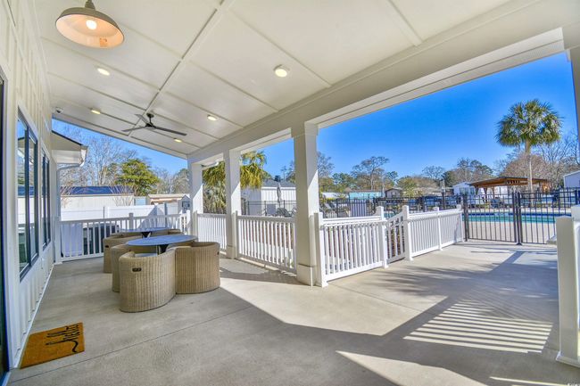 View of patio featuring ceiling fan and a community pool | Image 32