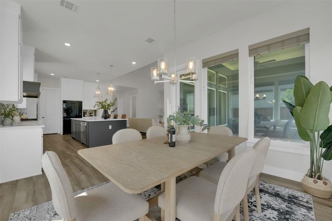 Dining area featuring a chandelier, dark wood-type flooring, visible vents, and recessed lighting | Image 14
