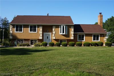 View of front of home featuring a front yard and professional landscaping. | Image 3