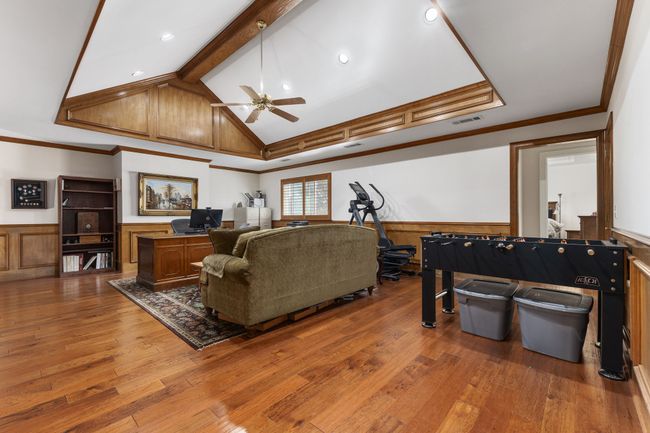Living area with wainscoting, lofted ceiling with beams, and hardwood / wood-style floors | Image 14