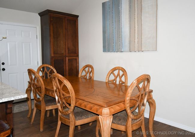 Dining area with baseboards and dark wood-style flooring | Image 17