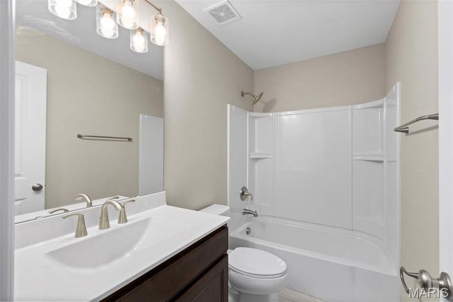 Full bathroom featuring vanity, toilet, and shower combination | Image 8