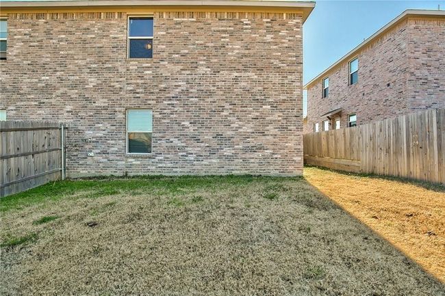 View of property exterior with a fenced backyard and brick siding | Image 17