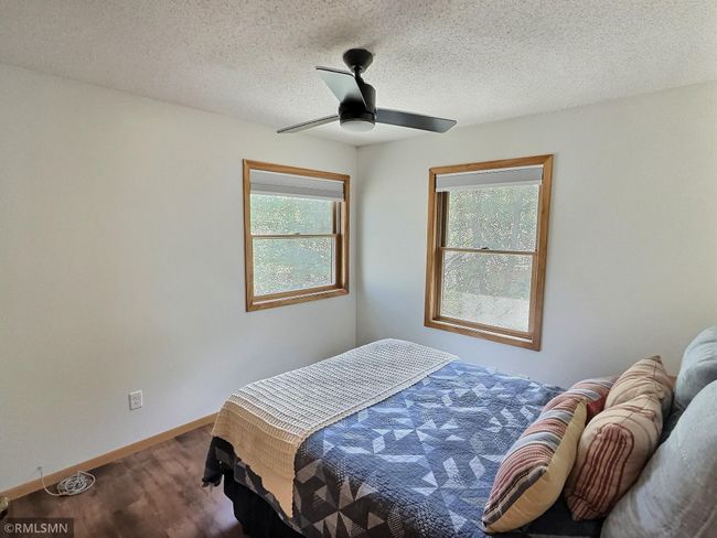 Perfect for weekend guests or kids, the second bedroom located in the upper level is bright with sunlight. | Image 23