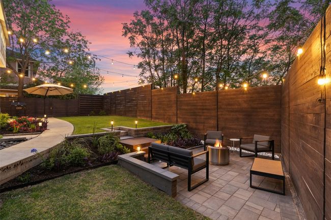 Wrap around back yard is perfect for relaxing on the large patio, tiered yard with sidewalk, privacy fencing and three gates. | Image 29