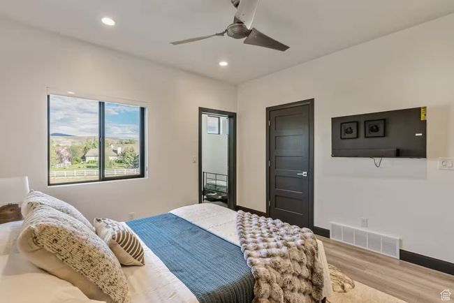Bedroom with recessed lighting, visible vents, baseboards, and wood finished floors | Image 62