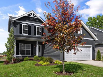 Craftsman house featuring a garage and a front lawn | Image 1