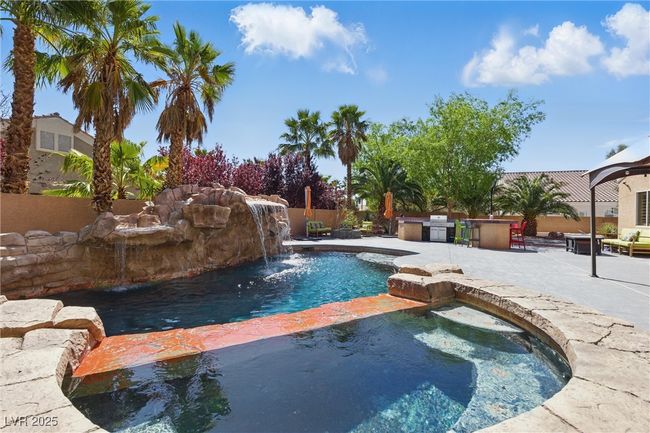 View of pool with fence, a patio area, a fenced in pool, and an in ground hot tub | Image 40