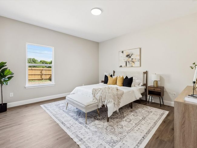 Bedroom featuring baseboards and wood finished floors | Image 13