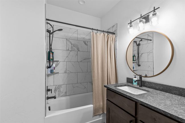 Full bath featuring shower / tub combo with curtain and vanity | Image 36