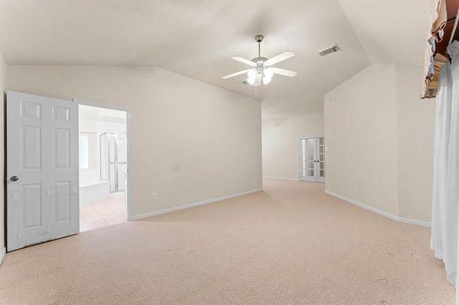 The spacious primary suite features high ceilings, soft natural light, and a bonus room attached - ideal for a sitting area, home office, or nursery. With an ensuite bath just beyond, this layout offers comfort, flexibility, and retreat-like privacy. | Image 21