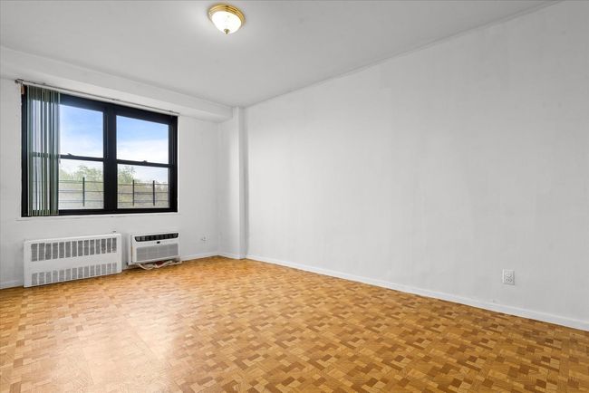 Spare room with radiator and baseboards | Image 12