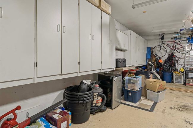 The three-car garage has an incredible amount of cabinetry for storage. | Image 29