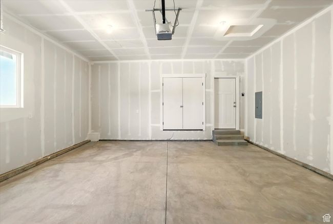 Garage featuring electric panel and a garage door opener | Image 31