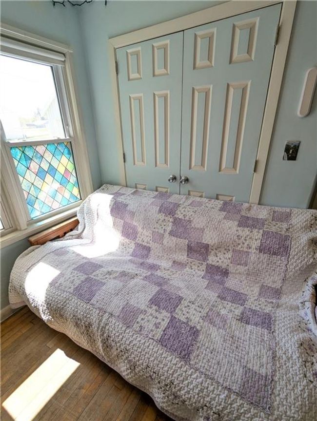Bedroom with hardwood / wood-style floors and a closet | Image 26