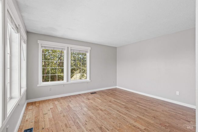 Empty room featuring light wood-type flooring and baseboards | Image 11