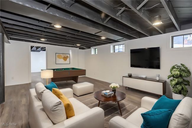 Living room with wood-type flooring and billiards | Image 42