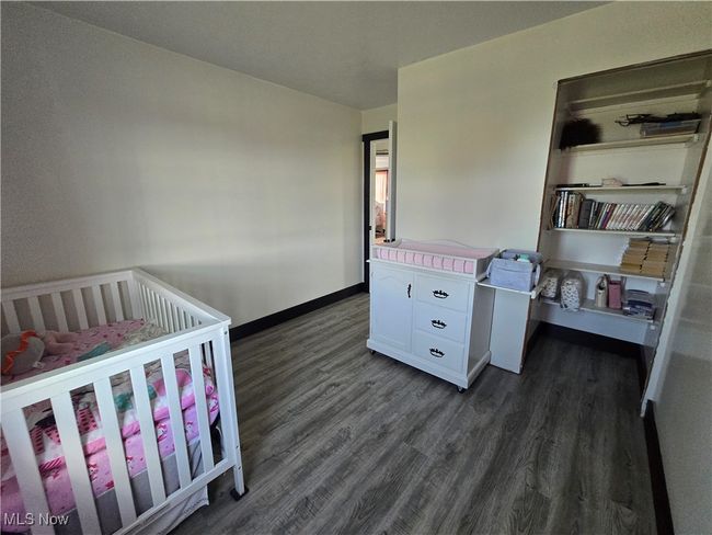 Bedroom with baseboards and dark wood-style floors | Image 25