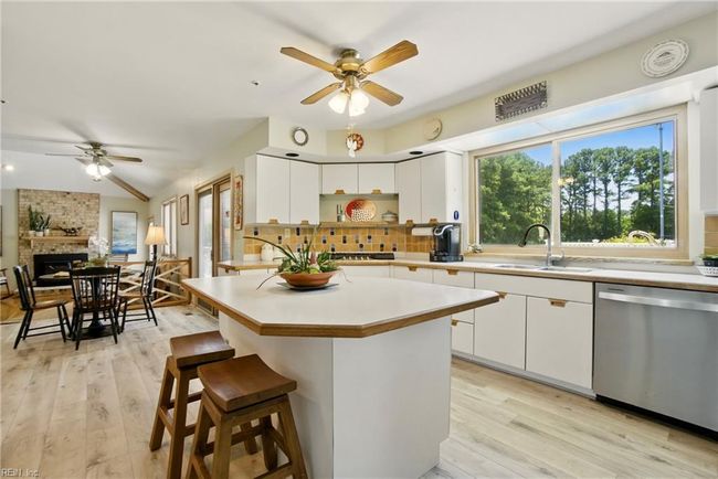 Kitchen overlooks the pool and the treelined backyard. | Image 11
