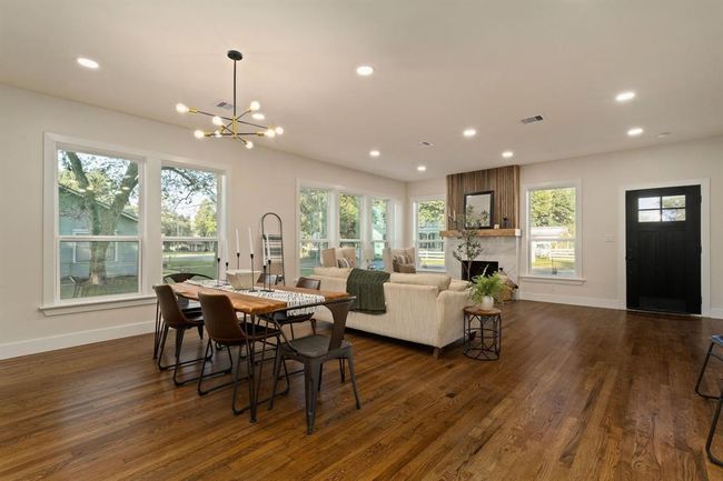 The family room opens directly to an elegant dining room which is illuminated by a striking Sputnik chandelier that adds a touch of modern sophistication. | Image 10