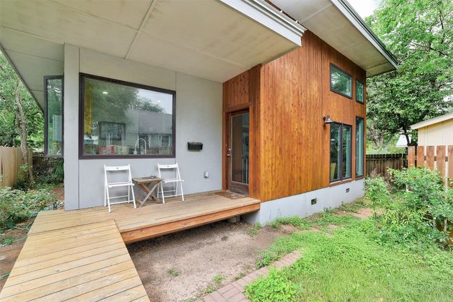 Back of property featuring a wooden deck, crawl space, and fence | Image 28