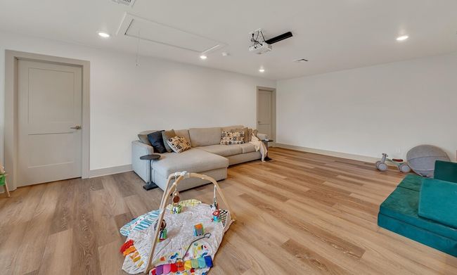 Living area with attic access, wood finished floors, and recessed lighting | Image 20