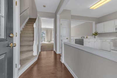 Inside is a entry area and wood laminate flooring | Image 3