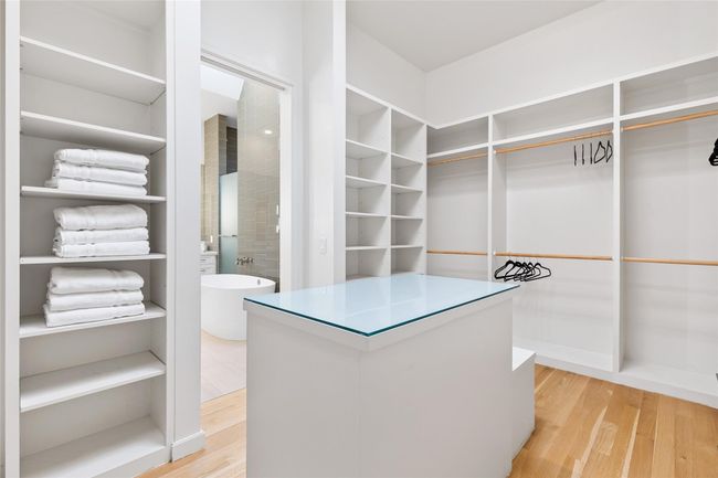 Spacious closet featuring light wood-type flooring | Image 20