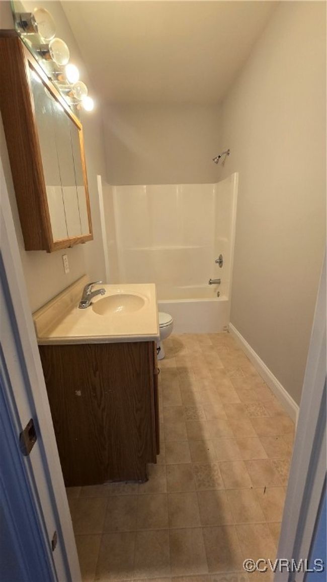 Full bathroom with toilet, baseboards, vanity, and shower / bath combination | Image 46