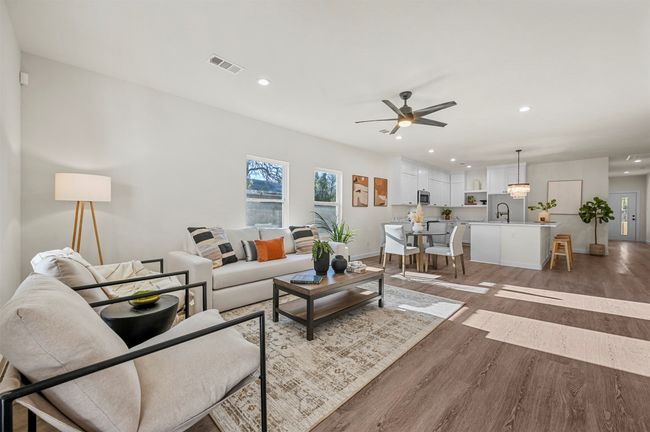 Living area featuring recessed lighting, light wood-style flooring, baseboards, visible vents, and a ceiling fan | Image 4