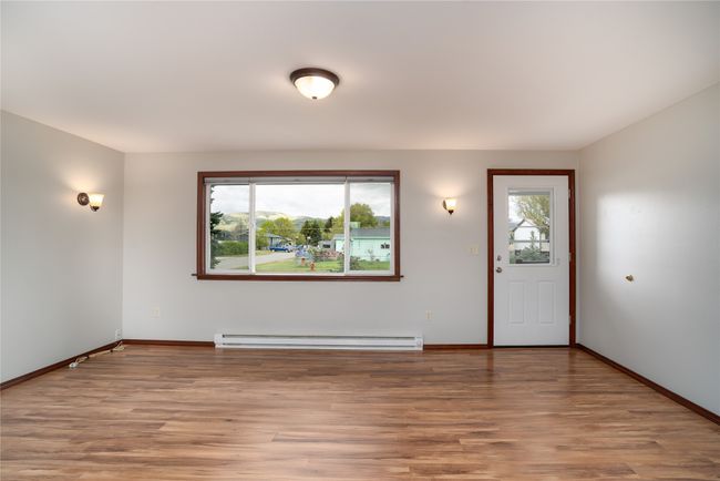 Foyer entrance featuring baseboard heating, light wood-type flooring, and baseboards | Image 9