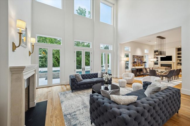 The room features a fireplace with ambient , and an open layout extending to a dining area. | Image 8