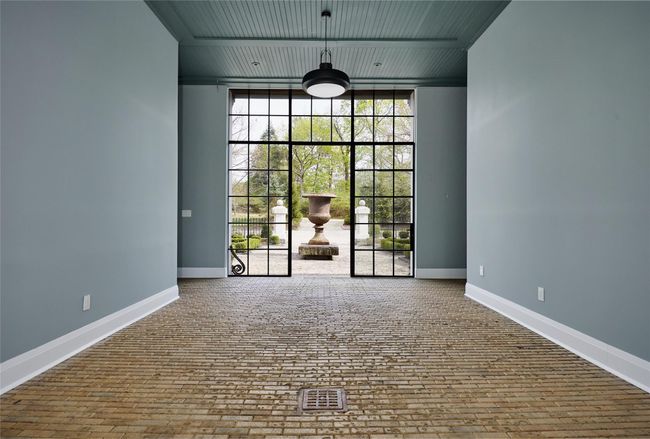 Unfurnished room with floor to ceiling windows, visible vents, and baseboards | Image 5