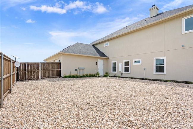Back of property featuring a chimney and stucco siding | Image 34